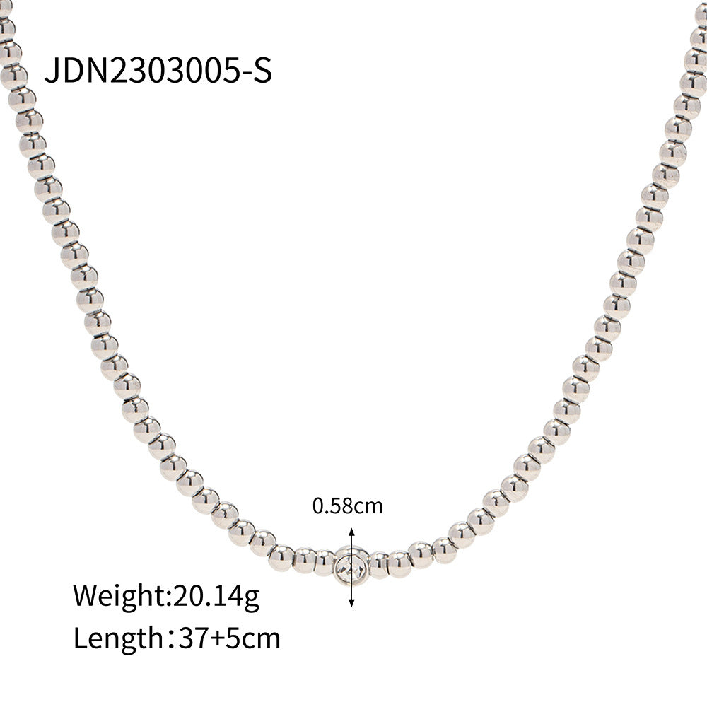 Minimalist Round Beaded Stainless Steel and Titanium Bracelet with 18K Gold Plating and Green Heart Zircon Charm