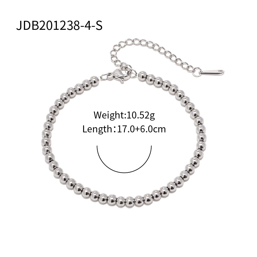 Minimalist Round Beaded Stainless Steel and Titanium Bracelet with 18K Gold Plating and Green Heart Zircon Charm