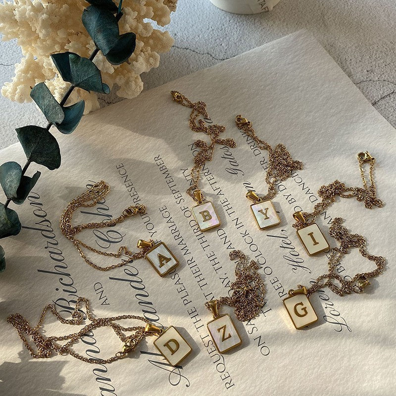 Unisex 18k Gold Plated Stainless Steel Letter Pendant Necklace with White Shell Accents