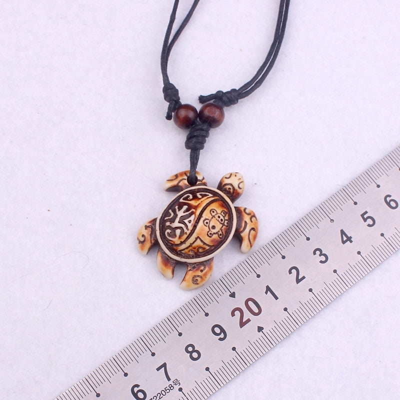 Ethnic Tortoise Resin Pendant Necklace with Faux Bone Carving